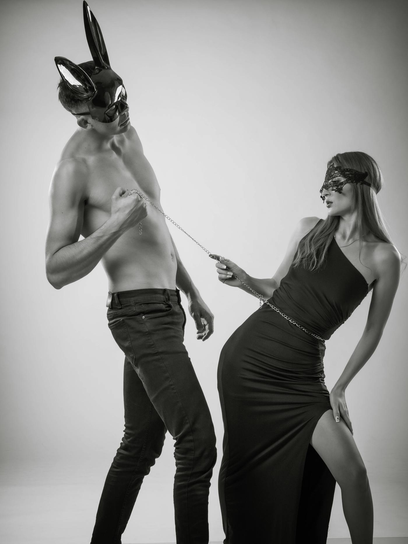 White model with a leather jacket draped over the shoulders in a soft studio portrait