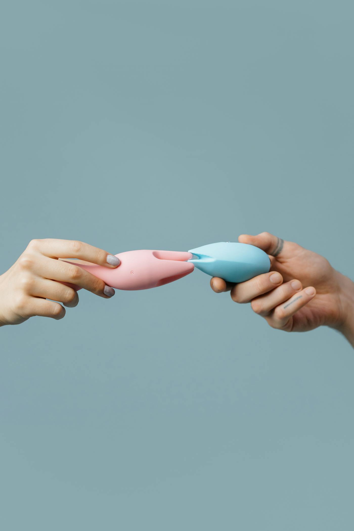 Hands holding two silicone wearable products