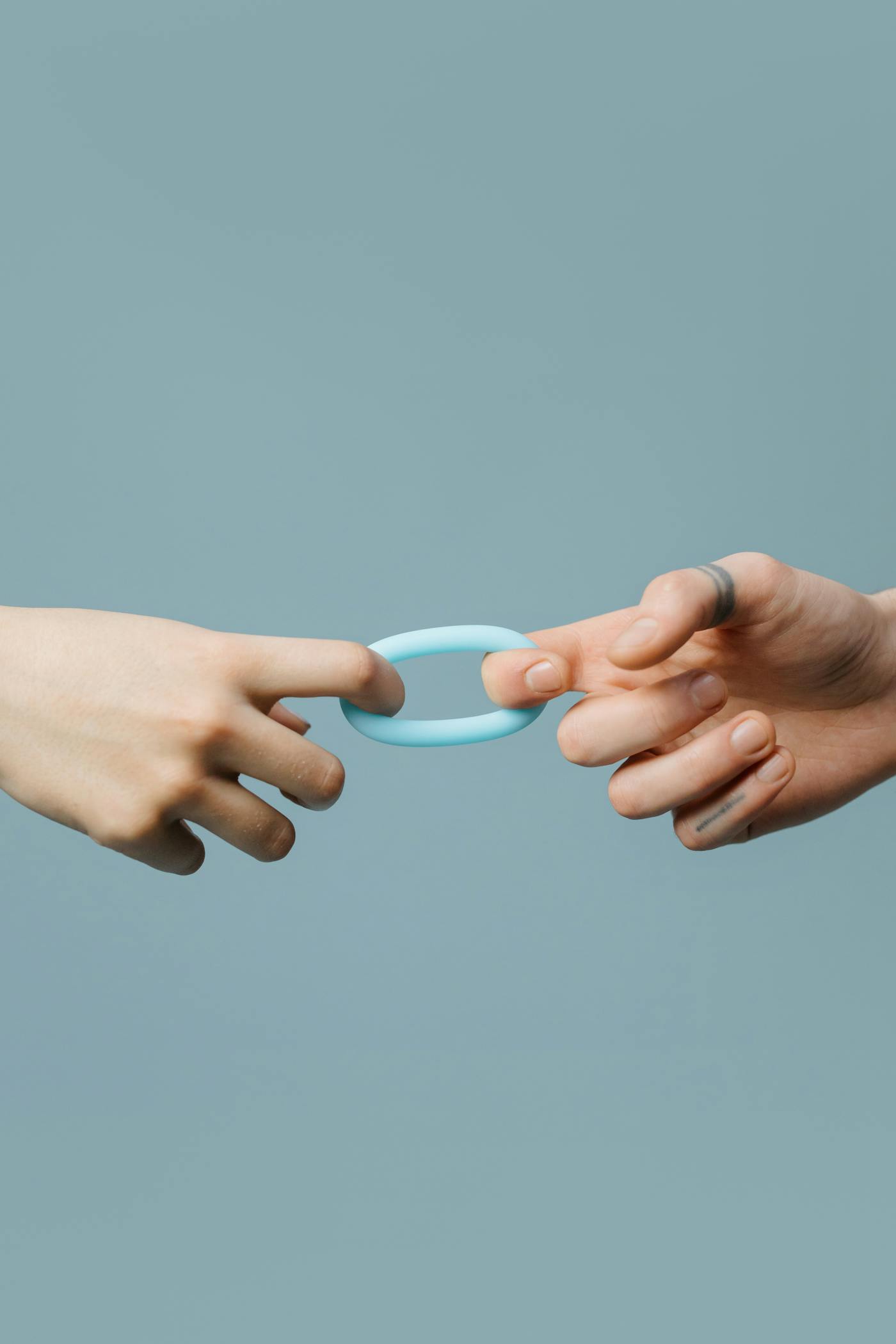 Hand holding a silicone toy on a purple background