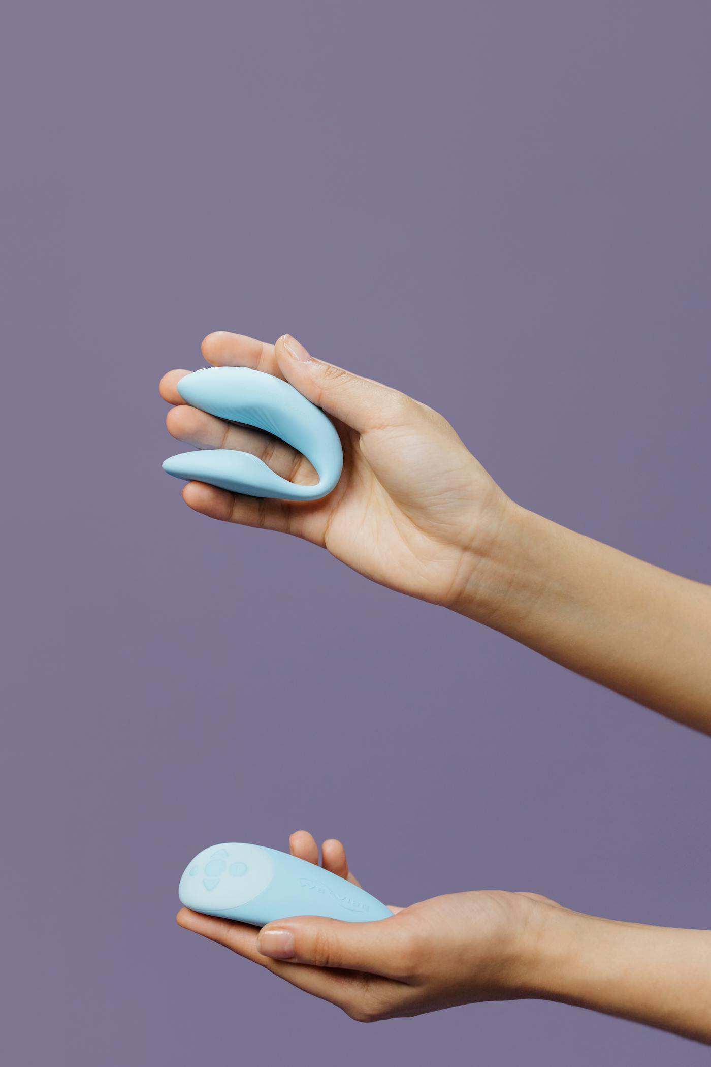Hands holding two silicone wearable products
