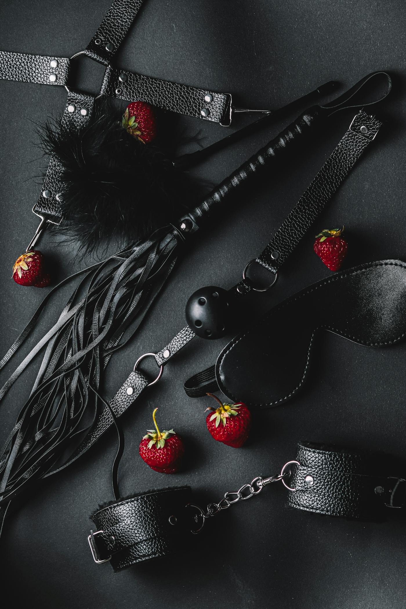 White model in a dark strappy outfit photographed in a warm portrait setting